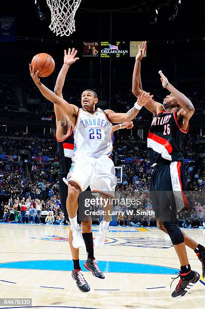 Earl Watson of the Oklahoma City Thunder goes to the basket against Travis Outlaw of the Portland Trail Blazers at the Ford Center on February 6,...