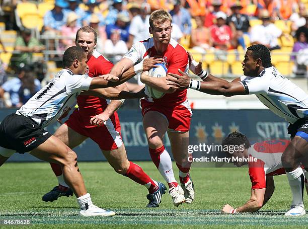 Rob Vickerman of England is tackled during the match between England and Fiji on day two of the New Zealand International Sevens at Westpac Stadium...