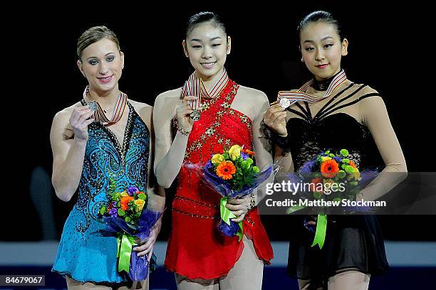 Joannie Rochette, Yu-Na Kim of Korea and Mao Asada of Japan pose for photographers on the winners podium after the Ladies Free Skate during the ISU...