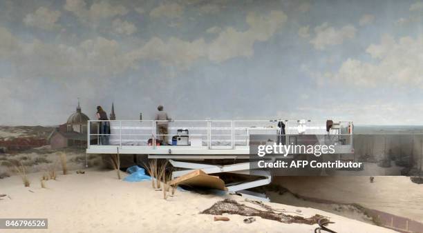 Art restorers Leonoor Speldekamp and Jorinde Koenen work on a raised platform during restoration work on the "Panorama Mesdag" by Dutch painter...