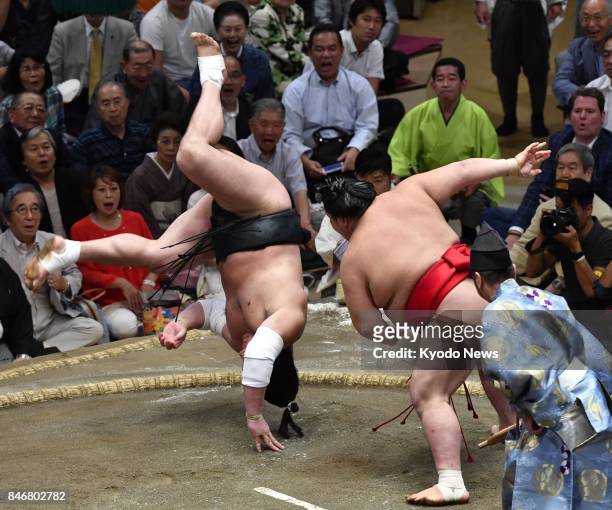 No. 3 maegashira Onosho slaps down yokozuna Harumafuji of Mongolia on the fifth day of the 15-day Autumn Grand Sumo Tournament at Tokyo's Ryogoku...