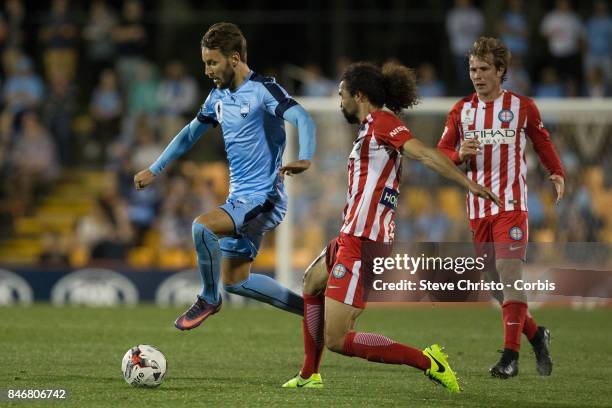 Milos Ninkovic of Sydney FC leaps past Melbourne City's Osama Malik during the FFA Cup Quarter Final match between Sydney FC and Melbourne City at...