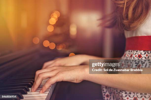 christmas. close up of the hands of a girl playing the piano. - child pianist stock pictures, royalty-free photos & images