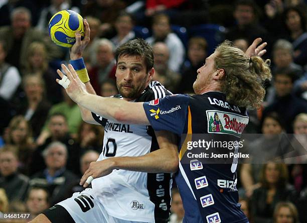 Stefan Loevgren of Kiel and Felix Lobedank of Balingen compete for the ball during the Handball Bundesliga match between THW Kiel and HBW...