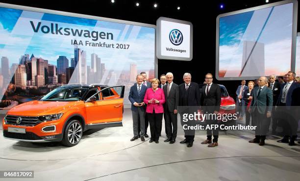 German Chancellor Angela Merkel and Volkswagen CEO Matthias Mueller , the president of the German Automobile Industry Association Matthias Wissmann ,...