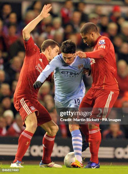 Manchester City's Samir Nasri is tackled by Liverpool's Daniel Agger and Glen Johnson during the Carling Cup, Semi Final, Second Leg match at...