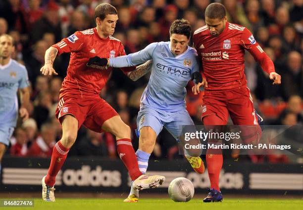 Manchester City's Samir Nasri is tackled by Liverpool's Daniel Agger and Glen Johnson during the Carling Cup, Semi Final, Second Leg match at...