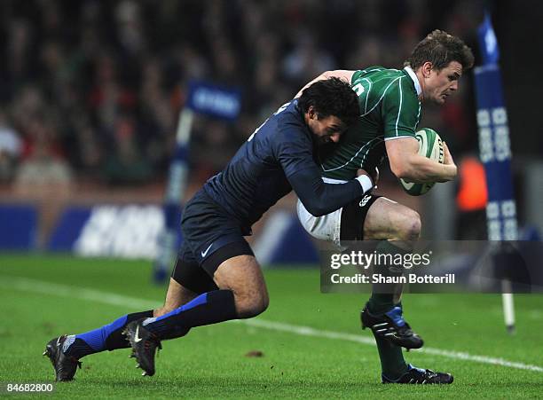 Clement Poitrenaud of France tackles Brian O'Driscoll of Ireland during the RBS 6 Nations Championship match between Ireland and France at Croke Park...