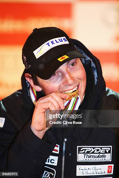 Race winner John Kucera of Canada celebrates with his Gold Medal after skiing to victory in the Men's Downhill event held on the Face de Bellevarde...