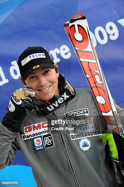 Race winner John Kucera of Canada celebrates with his Gold Medal after skiing to victory in the Men's Downhill event held on the Face de Bellevarde...