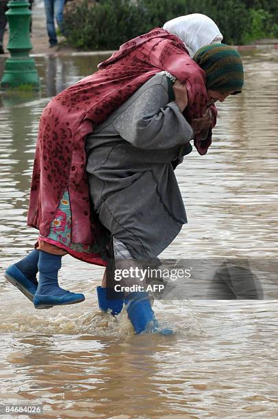 Two women negotiate flood water in the Moroccan town of Souk Larbaa, near Kenitra. A communique from the Moroccan interior ministry has stated that...