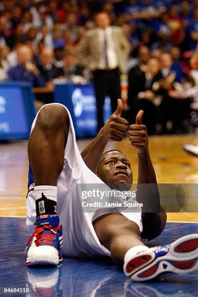 Mario Little of the Kansas Jayhawks gives the jump ball sign after falling to the floor during the game against the Oklahoma State Cowboys on...