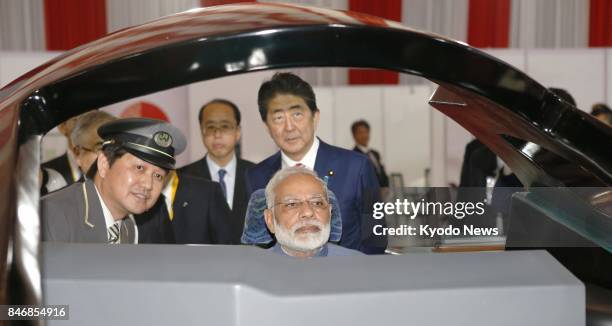 Japanese Prime Minister Shinzo Abe and Indian Prime Minister Indian Prime Minister Narendra Modi inspect a high-speed train simulator in Gandhinagar,...