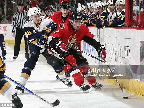Mike Fisher of the Ottawa Senators stickhandles the puck against pressure from Patrick Kaleta of the Buffalo Sabres at Scotiabank Place on February...
