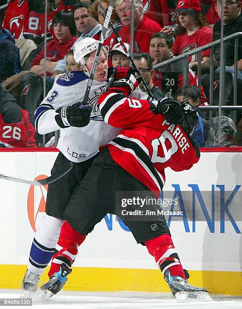 Jack Johnson of the Los Angeles Kings roughs up Zach Parise of the New Jersey Devils at the Prudential Center on February 7, 2009 in Newark, New...