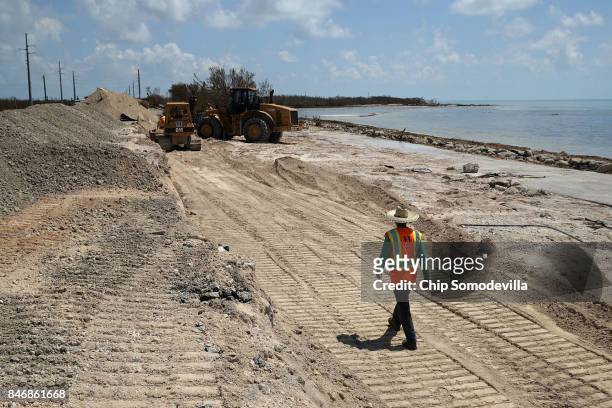 Earth movers clear away sand while preparing to repair the two northbound lanes of Highway 1 washed out by Hurricane Irma September 13, 2017 in Bahia...