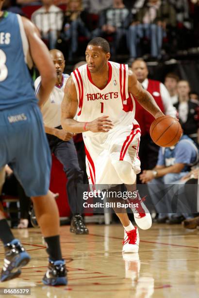 Tracy McGrady of the Houston Rockets drives the ball past Ryan Gomes of the Minnesota Timberwolves on February 7, 2009 at the Toyota Center in...