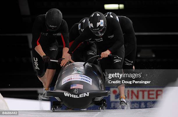 Driver Steven Holcomb of the USA and his crew push from the start on their first run as they finished second in the men's four man bobsleigh finals...