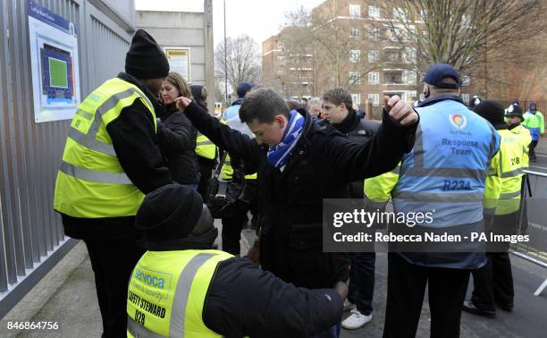 Fan is searched by a safety steward ahead of the FA Cup, Fourth Round match at Loftus Road, London.