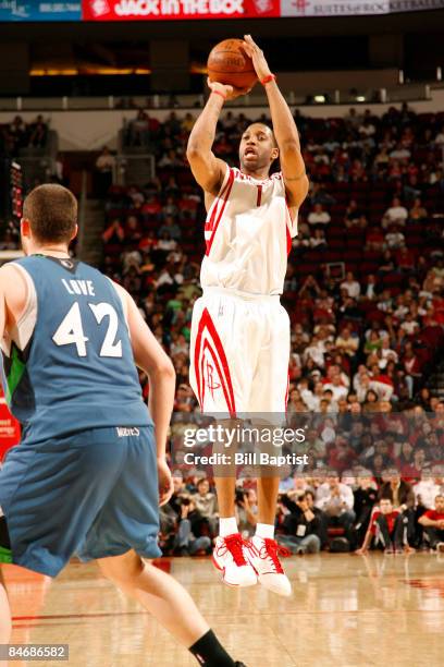 Tracy McGrady of the Houston Rockets shoots the ball over Kevin Love of the Minnesota Timberwolves on February 7, 2009 at the Toyota Center in...