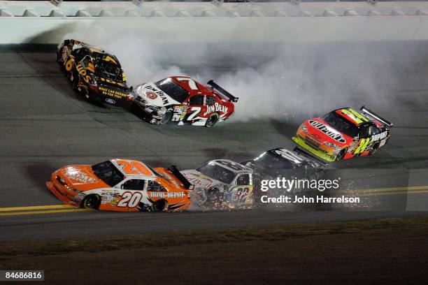 David Ragan, driver of the UPS Ford, and Robby Gordon, driver of the Jim Beam Dodge, crash while Joey Logano, driver of the Home Depot Toyota, and...