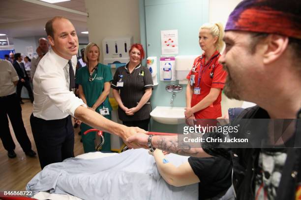 Prince William, Duke of Cambridge meets the husband of a patient during a visit to Aintree University Hospital on September 14, 2017 in Liverpool,...