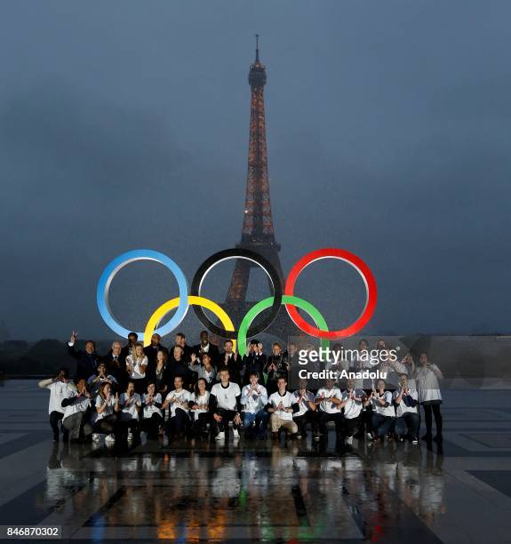French athletes pose in front of Olympic rings to celebrate the Paris 2024 Olympic bid victory in Paris, France on September 14, 2017.