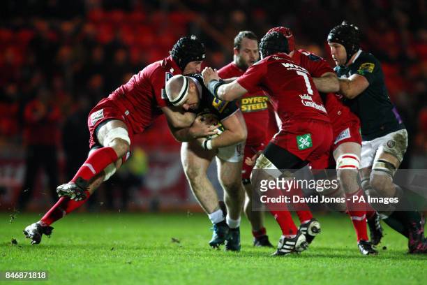 London Irish's Clarke Dewrmody is tackled by Llanelli Scarlets' Dominic Day during the LV=Cup match at Parc Y Scarlets, Llanelli.
