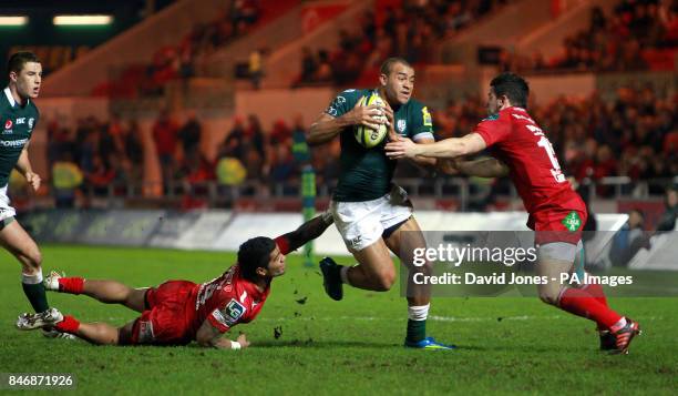 London Irish's Jonathan Joseph tries to evade Llanelli Scarlets' Vili Iongi and Gareth Maule during the LV=Cup match at Parc Y Scarlets, Llanelli.