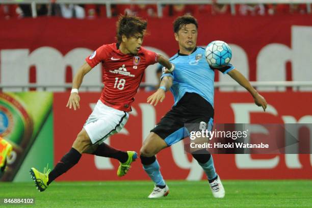 Yoshiaki Komai of Urawa Red Diamonds and Yusuke Tasaka of Kawasaki Frontale compete for the ball during the AFC Champions League quarter final second...