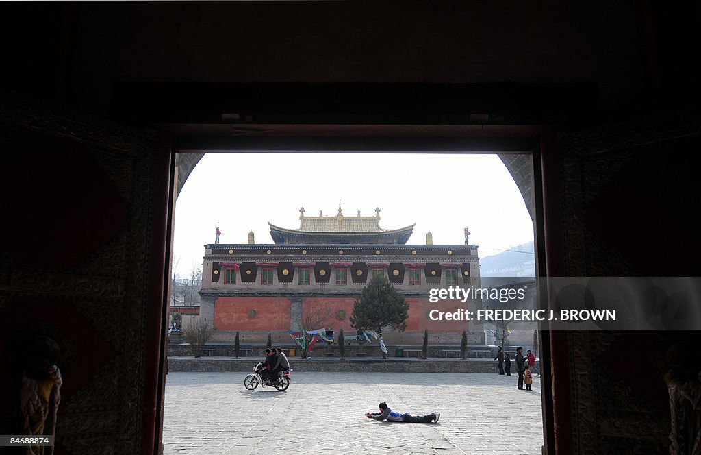 A Tibetan Buddhist prostrates himself in