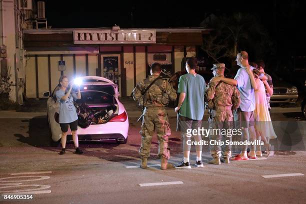 Residents pose for photographs with soldiers from Delta Company, 1st Battallion, 124th Infantry, 53rd Infantry Brigade Combat Team as they work to...