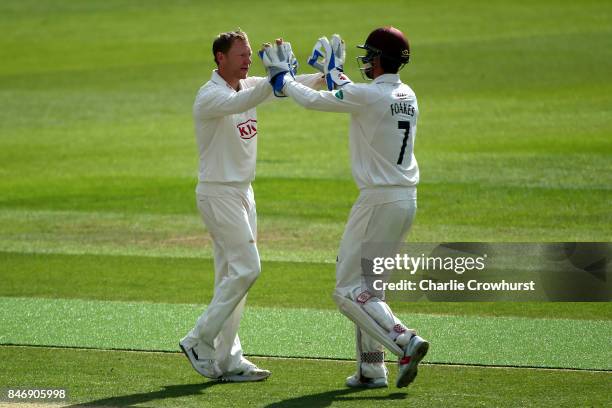 Surrey's Gareth Batty celebrates with team mate Ben Foakes after taking the wicket of Yorkshire's Tim Bresnan during day three of the Specsavers...