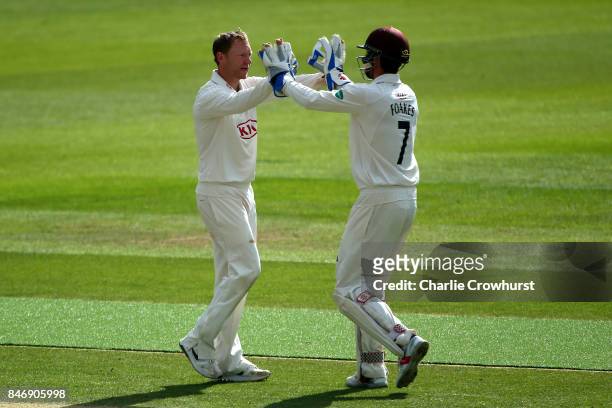 Surrey's Gareth Batty celebrates with team mate Ben Foakes after taking the wicket of Yorkshire's Tim Bresnan during day three of the Specsavers...