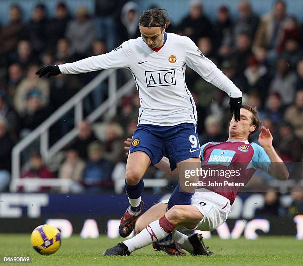 Dimitar Berbatov of Manchester United clashes with Scott Parker of West Ham United during the Barclays Premier League match between West Ham United...