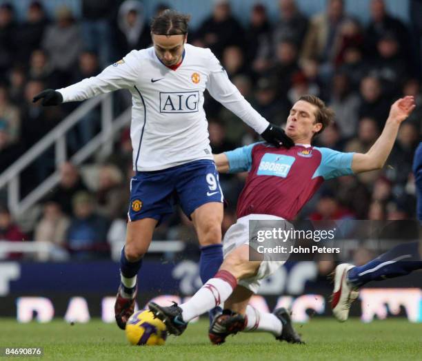 Dimitar Berbatov of Manchester United clashes with Scott Parker of West Ham United during the Barclays Premier League match between West Ham United...