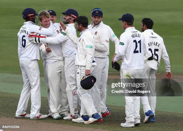 Simom Harmer of Essex celebrates with team mates after taking the final wicket of Henry Brookes during the victory in the Specsavers County...