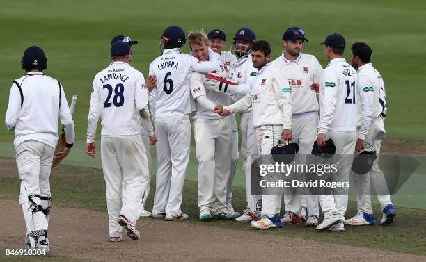 Simom Harmer of Essex celebrates with team mates after taking the final wicket of Henry Brookes during the victory in the Specsavers County...