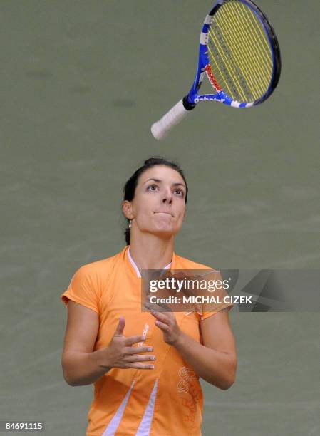 Nuria Llagostera Vives of Spain throws her raquette during a Fed Cup World Group first round match against Petra Kvitova of the Czech Republic on...