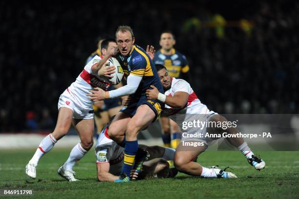 Leeds Rhinos' Carl Ablett is tackled by Hull Kingston Rovers' Lincoln Withers and Constantine Mika during the Stobart Super League match at...