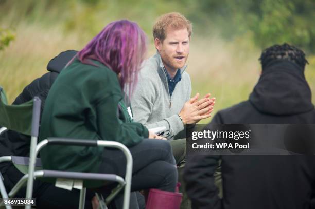 Prince Harry talks to teenagers taking part in the TurnAround Project, run by the Wilderness Foundation to provide support and activities for...