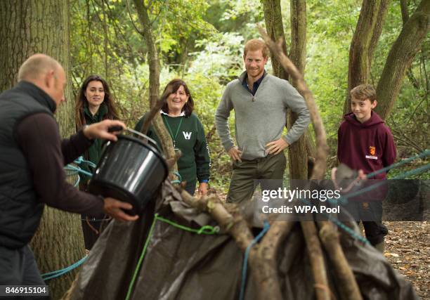 Prince Harry builds shelters with Felstead Prep School year 7 pupils as he visits The Chatham Green Project, a conservation and educational...