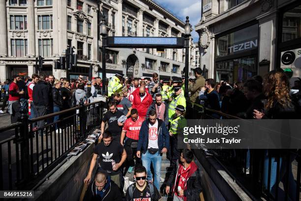 Cologne football fans make their way into Oxford Circus underground station ahead of the FC Koln match against Arsenal this evening on September 14,...