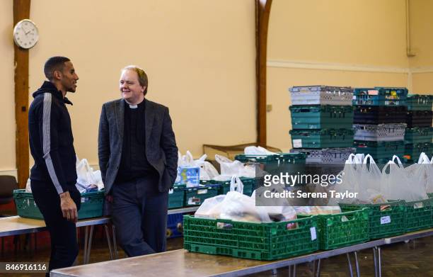 Isaac Hayden of Newcastle United talks with Reverend Dominic Coad Vicar of Church of the Venerable Bede during a visit to Newcastle West End Foodbank...