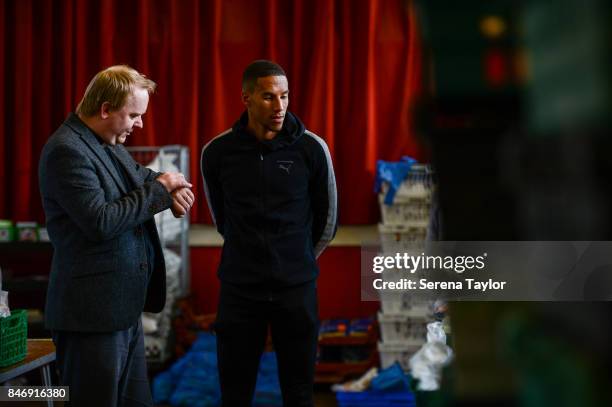 Isaac Hayden of Newcastle United talks with Reverend Dominic Coad Vicar of Church of the Venerable Bede during a visit to Newcastle West End Foodbank...