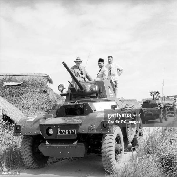 Seated in the turret of a Daimler Armoured Car, Mr Oliver Lyttelton, Colonial Secretary visits a resettlement area in Johore during his tour of...