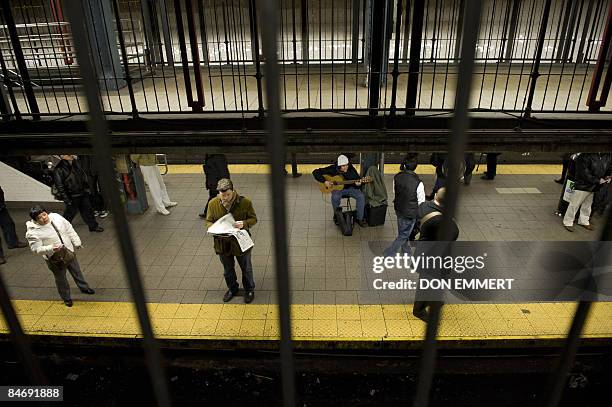 Thalys Peterson Quaresma plays the guitar in the subway station at Union Square January 30, 2009 in New York. Scores, perhaps hundreds, of freelance...