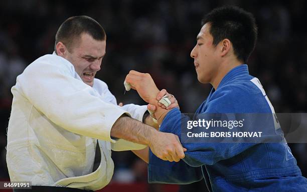 Japanese Takamasa Anai battles with Byelorussian Yauhen Biadulin on February 8 during their men final round in the -100 kg category at the Paris judo...