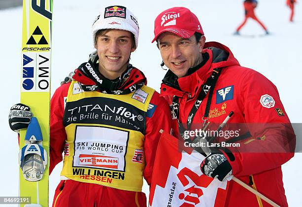 Gregor Schlierenzauer of Austria celebrates with his coach Alexander Pointner after winning the FIS Ski World Cup at the Muehlenkopfschanze on...