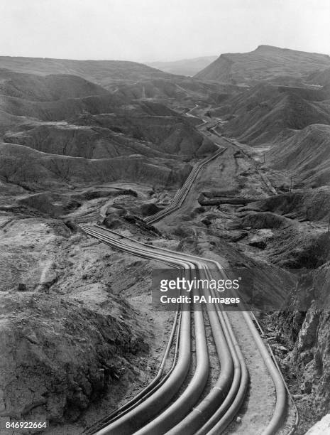 Pipelines belonging to the Anglo-Iranian Abadan oil refinery weave through the mountainous oilfield area of Persia, Iran